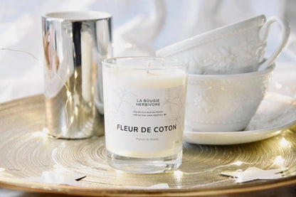 Bougie parfumée fleur de coton 150g de La Bougie Herbivore sur un plateau décoratif avec des tasses en porcelaine