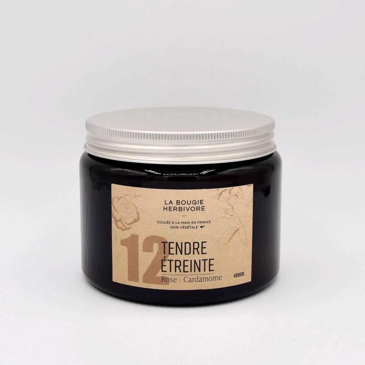 Bougie rose cardamome de La Bougie Herbivore dans un pot en verre noir avec couvercle blanc